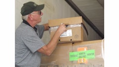 A George’s employee takes the temperature of a refrigerated chicken package in transit.