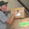 A George’s employee takes the temperature of a refrigerated chicken package in transit.