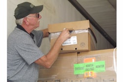 A George’s employee takes the temperature of a refrigerated chicken package in transit.