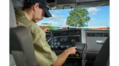A driver enters hours of service information using a Cadec onboard computer.