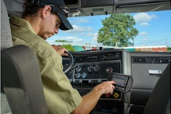 A driver enters hours of service information using a Cadec onboard computer.