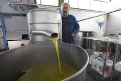 In this Thursday, Nov. 13, 2014 photo, Augusto Spagnoli, oil producer, shows how his oil mill works, during an interview with The Associated Press, in Nerola, 50 kilometers (31 miles) from Rome. Italy’s 2014 olive harvest was declared by both producers and experts as the worst in history, due to adverse climatic conditions which helped the olive fly proliferate thus destroying the olives before they could be harvested. (AP Photo/Alessandra Tarantino)