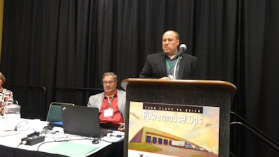 Sean Jones explains Eby-Brown’s rerouting efforts. Matt Granlund of Merchants Foodservice, seated, listens attentively.