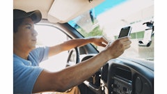 A delivery driver check out details in real-time on his Zebra Technologies enterprise-class mobile device.