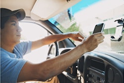 A delivery driver check out details in real-time on his Zebra Technologies enterprise-class mobile device.
