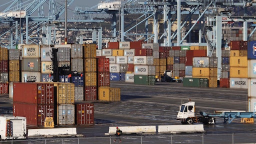 A dock worker arrives at the Port of Los Angeles on Monday, Feb. 23, 2015. Nearly all West Coast seaports began the week with dockworkers hustling to load and unload cargo ships that were held up amid a months-long labor-management dispute.