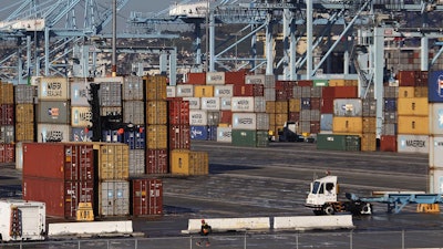 A dock worker arrives at the Port of Los Angeles on Monday, Feb. 23, 2015. Nearly all West Coast seaports began the week with dockworkers hustling to load and unload cargo ships that were held up amid a months-long labor-management dispute.