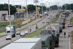 Striking truckers block a federal highway in Goiania, Brazil, Wednesday, Feb. 25, 2015. Weeklong protests by Brazilian truckers demanding lower fuel and toll prices have spread, causing shortages of gasoline and other products.