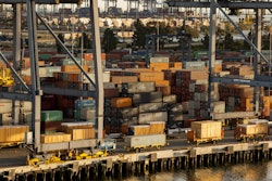 In this Wednesday, Jan. 14, 2015 file photo, shipping containers are stacked up waiting for truck transport at the Port of Los Angeles.