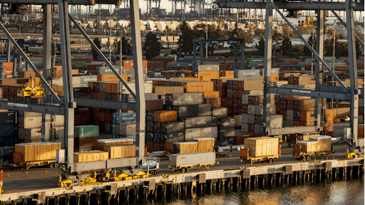 In this Wednesday, Jan. 14, 2015 file photo, shipping containers are stacked up waiting for truck transport at the Port of Los Angeles.