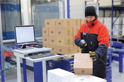 A worker in a cold storage facility uses the Viastore WMS via radio frequency for paperless picking.