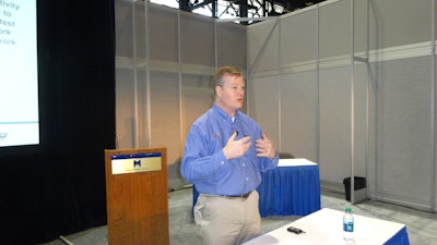 Art Eldred of Vargo Companies explains the benefits of waveless picking during the ProMat show in Chicago.