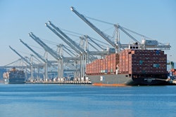 The massive post-Panamax cranes and container ships of the deepwater Port of Oakland seen from Alameda Point.