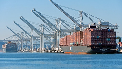 The massive post-Panamax cranes and container ships of the deepwater Port of Oakland seen from Alameda Point.