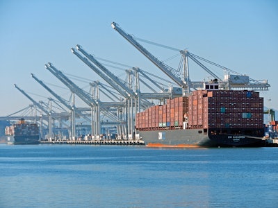 The massive post-Panamax cranes and container ships of the deepwater Port of Oakland seen from Alameda Point.