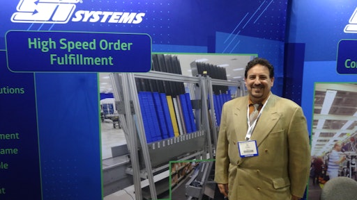 Ed Romaine shows a Mobile-atic dispensing system at the SI Systems booth.