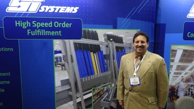 Ed Romaine shows a Mobile-atic dispensing system at the SI Systems booth.
