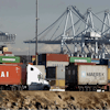 Semi trucks hauling a containers leave the Port of Los Angeles on Monday, Feb. 23, 2015. Nearly all West Coast seaports began the week with dockworkers hustling to load and unload cargo ships that were held up amid a months-long labor-management dispute.