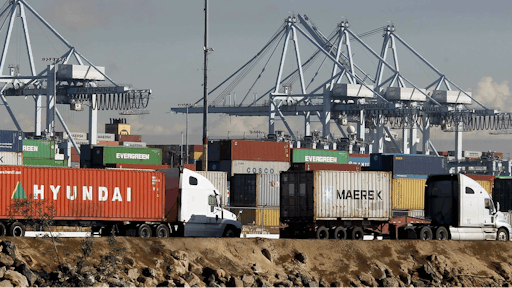 Semi trucks hauling a containers leave the Port of Los Angeles on Monday, Feb. 23, 2015. Nearly all West Coast seaports began the week with dockworkers hustling to load and unload cargo ships that were held up amid a months-long labor-management dispute.