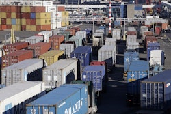 Loaded container trucks line-up at a gate at the Port of Seattle, Tuesday, Feb. 17, 2015, in Seattle.