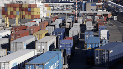 Loaded container trucks line-up at a gate at the Port of Seattle, Tuesday, Feb. 17, 2015, in Seattle.