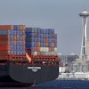 FILE - In this Feb. 15, 2015 file photo, the Space Needle towers in the background beyond a container ship anchored in Elliott Bay near downtown Seattle.