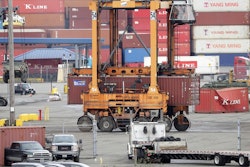 A cargo container is moved at the Port of Tacoma, Friday, Feb. 20, 2015, in Tacoma, Wash.