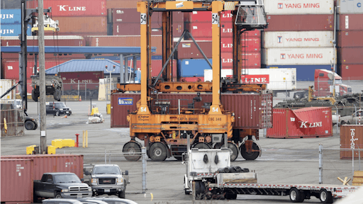 A cargo container is moved at the Port of Tacoma, Friday, Feb. 20, 2015, in Tacoma, Wash.
