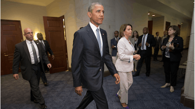 FILE - In this June 12, 2015 file photo, President Barack Obama and House Minority Leader Nancy Pelosi of Calif., leave meeting with House Democrats on Capitol Hill in Washington to discuss the global trade talks.