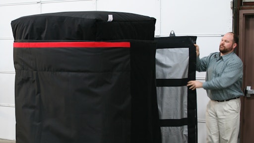 Anthony Dellumo at Q Products & Services readies a quilt to go on a trailer to haul frozen product.