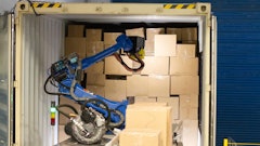 A Wynright robotic truck unloader palletizes in a warehouse.