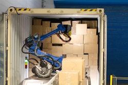 A Wynright robotic truck unloader palletizes in a warehouse.