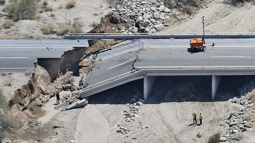 This aerial photo shows the collapsed elevated section of Interstate 10, Monday, July 20, 2015, in Desert Center, Calif. All traffic along one of the major highways connecting California and Arizona was blocked indefinitely when the bridge over a desert wash collapsed during a major storm, and the roadway in the opposite direction sustained severe damage.