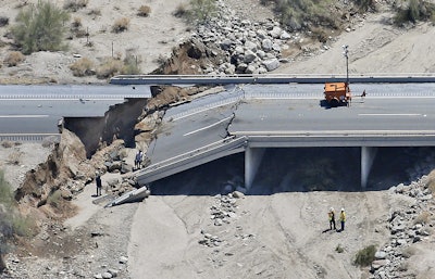 This aerial photo shows the collapsed elevated section of Interstate 10, Monday, July 20, 2015, in Desert Center, Calif. All traffic along one of the major highways connecting California and Arizona was blocked indefinitely when the bridge over a desert wash collapsed during a major storm, and the roadway in the opposite direction sustained severe damage.