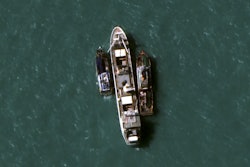 In this July 14, 2015, image provided by DigitalGlobe, a high-resolution satellite photograph off the coast of Papua New Guinea shows two fishing trawlers loading slave-caught fish onto Silver Sea 2, a refrigerated cargo ship belonging to the Thai-owned Silver Sea Fishery Co. The company was named in an Associated Press investigation into slavery in Southeast Asia’s seafood industry that led to the rescue and repatriation of more than 800 men. Hundreds more remain missing after their trawlers fled an Indonesian crackdown on illegal fishing.