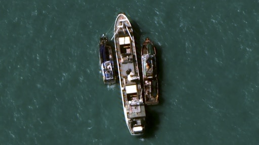 In this July 14, 2015, image provided by DigitalGlobe, a high-resolution satellite photograph off the coast of Papua New Guinea shows two fishing trawlers loading slave-caught fish onto Silver Sea 2, a refrigerated cargo ship belonging to the Thai-owned Silver Sea Fishery Co. The company was named in an Associated Press investigation into slavery in Southeast Asia’s seafood industry that led to the rescue and repatriation of more than 800 men. Hundreds more remain missing after their trawlers fled an Indonesian crackdown on illegal fishing.