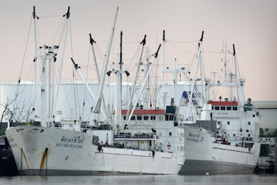 In this Dec. 10, 2014, photo, two refrigerated cargo ships, Silver Sea 2, right, and Silver Sea Line, left, are docked alongside one another at Thajeen Port in Samut Sakhon, Thailand. Both are owned by Thailand''s Silver Sea Fishery Co., named in an Associated Press investigation into slavery in Southeast Asia’s seafood industry. At the AP''s request, the Colorado-based satellite company, DigitalGlobe, used its high-powered, satellite lenses and managed to catch the Silver Sea 2 as it was being loaded with slave-caught fish on waters off Papua New Guinea.
