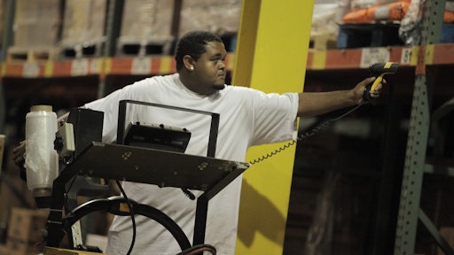 A warehouse employee scans a bar code label.