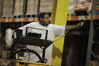A warehouse employee scans a bar code label.