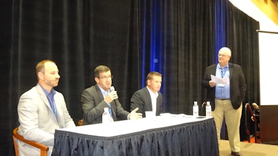 Jon Van Winkle of Omnitracs LLC, center, fields a question on onboard computer technology, flanked by Rustin Keller of J.J. Keller Associates (left) and Rick Ochsendorf of PeopleNet. Lynn Conn of F.A.B. Inc. moderates.