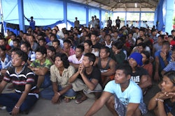 In this April 20, 2015, photo, former fishing slaves who were rescued from Indonesia’s remote island village of Benjina gather at a temporary government-run shelter on the island of Tual, Indonesia. Hundreds of men remain unaccounted for and are believed to be fishing in Papua New Guinea.