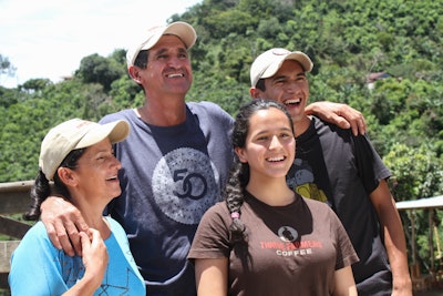 Franco Garbanzo, one of the first farmers to partner with THRIVE Farmers, smiles with his family on their farm 'La Violeta' in Tarrazu, Costa Rica.