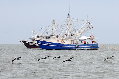 1024px Shrimp boats tow fire resistant oil containment boom in Gulf of Mexico 2010 05 03 2 597797e6e5dc7
