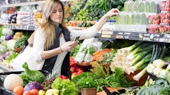 Woman Grocery Shopping With Phone