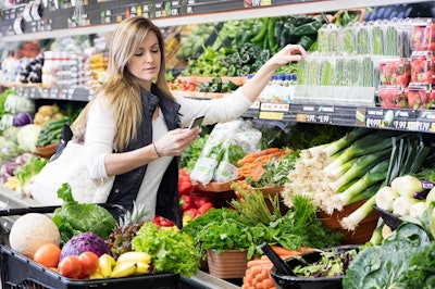 Woman Grocery Shopping With Phone