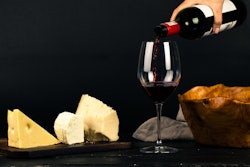 Photo Of Person Pouring Wine Into Glass Besides Some Cheese 1545529