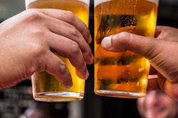 Two Persons Holding Drinking Glasses Filled With Beer 1089930