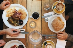 Assorted Variety Of Foods On Plates On Dining Table 1528013