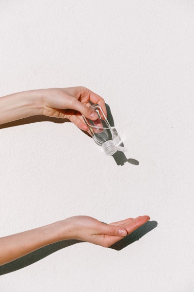 Person Holding Hand Sanitizer 3962332