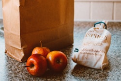 Several Apples Beside Bread Pack And Brown Paper Bag 1992912